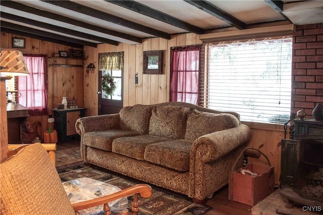 living room featuring vaulted ceiling with beams and wooden walls