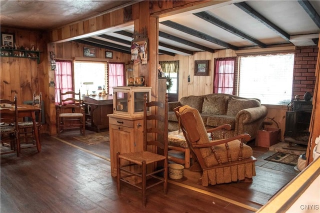 living room with vaulted ceiling with beams, dark hardwood / wood-style flooring, and wooden walls