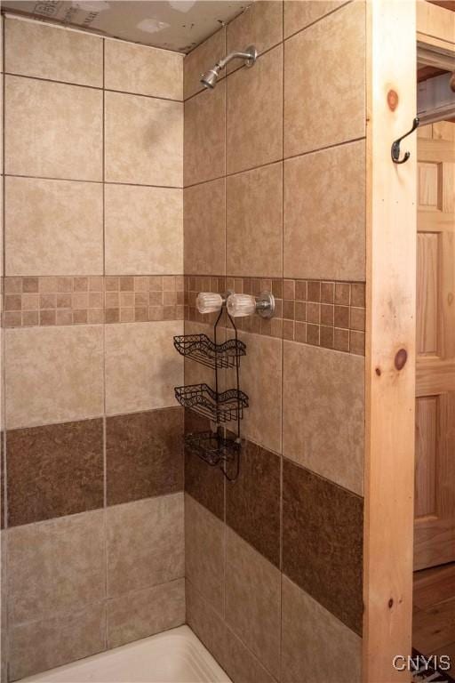 bathroom with a tile shower