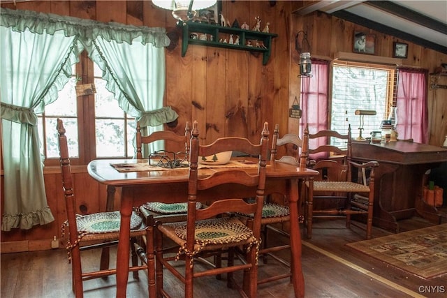 dining room with hardwood / wood-style flooring, wood walls, and vaulted ceiling