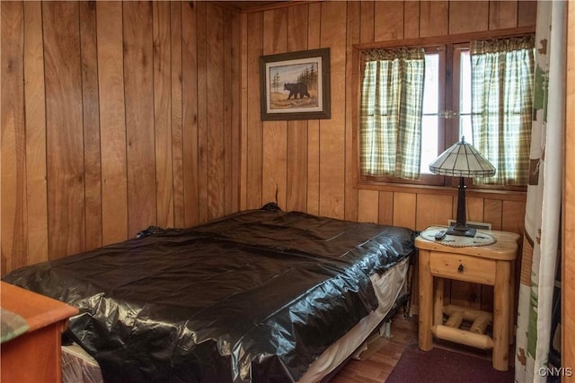 bedroom featuring wooden walls