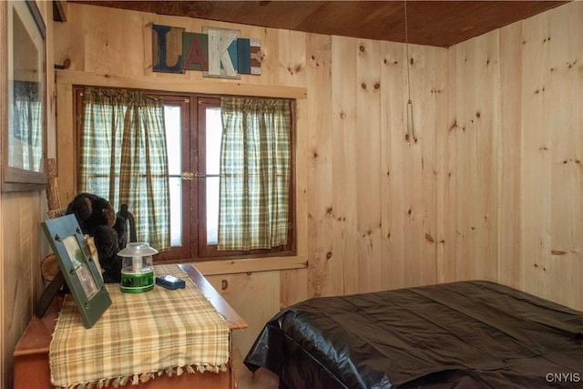 bedroom featuring wood walls