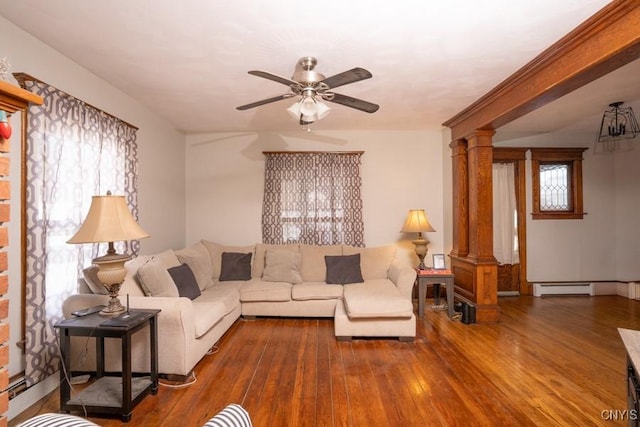 living room featuring a baseboard heating unit, ceiling fan, plenty of natural light, dark hardwood / wood-style floors, and decorative columns