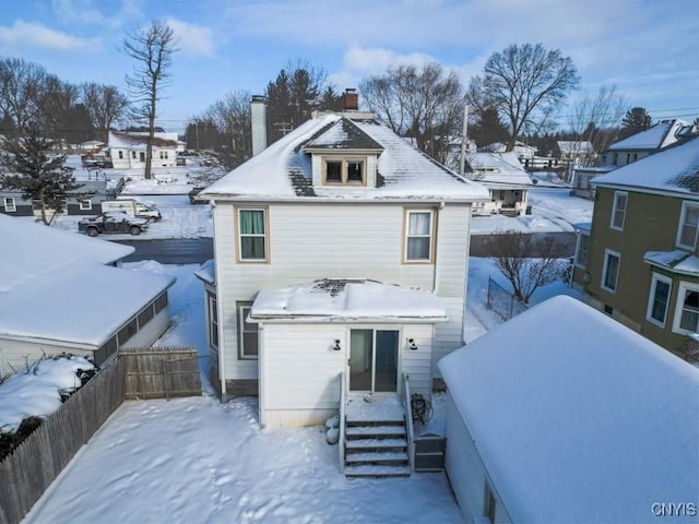 view of snow covered rear of property