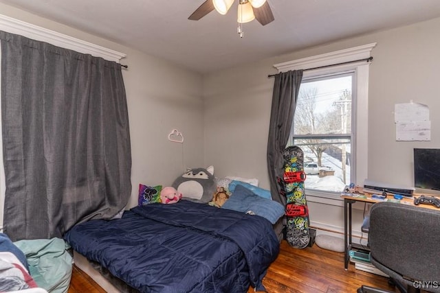 bedroom with ceiling fan and dark hardwood / wood-style flooring