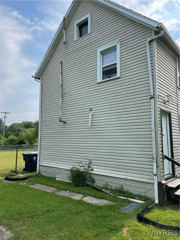 view of side of home featuring a yard