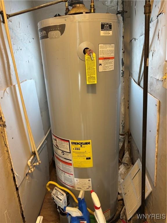 utility room featuring water heater