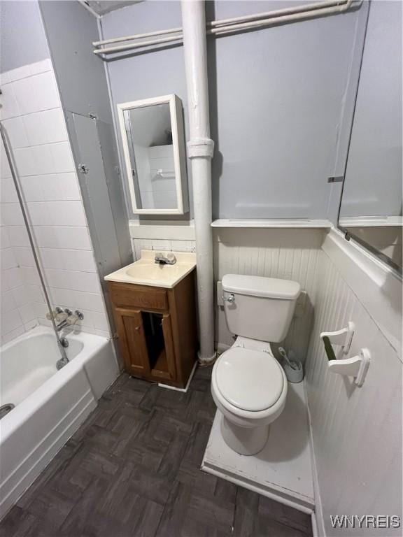 full bathroom featuring toilet, parquet flooring, vanity, and shower / washtub combination