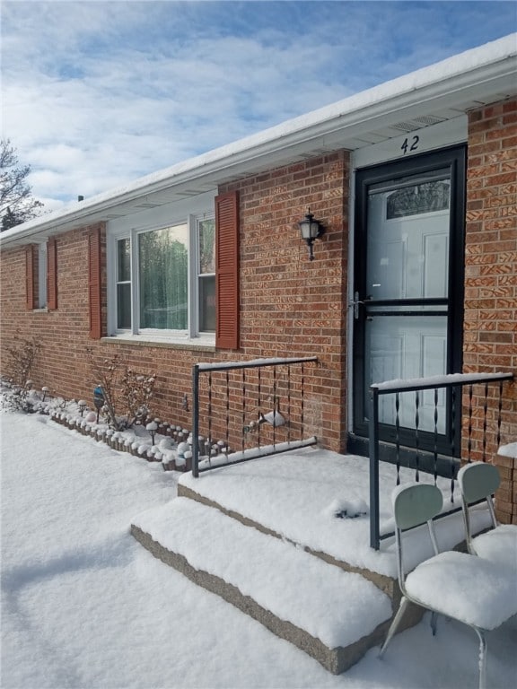 view of snow covered property entrance