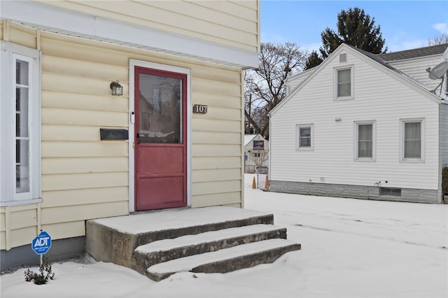 view of snow covered property entrance