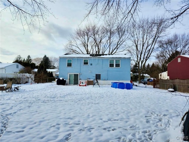 snow covered property featuring a swimming pool