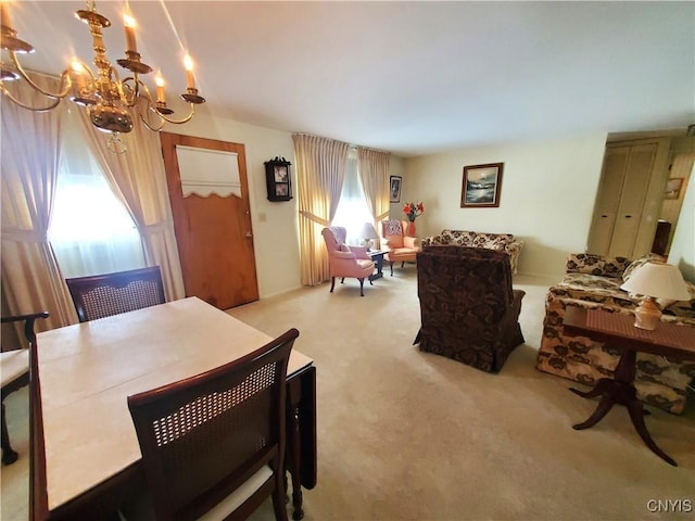 dining room with a notable chandelier and carpet flooring