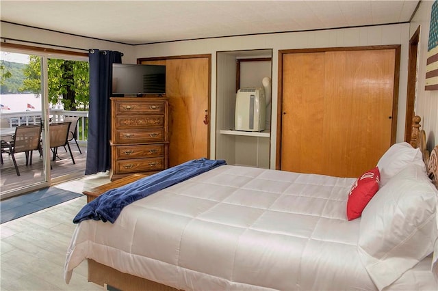 bedroom featuring access to outside and light hardwood / wood-style flooring