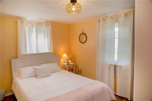 bedroom with hardwood / wood-style flooring