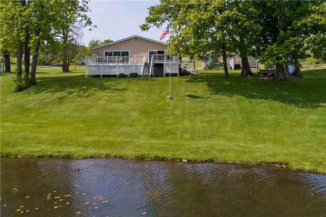 view of yard featuring a deck with water view