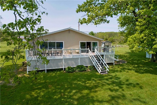 back of property with a deck and a lawn