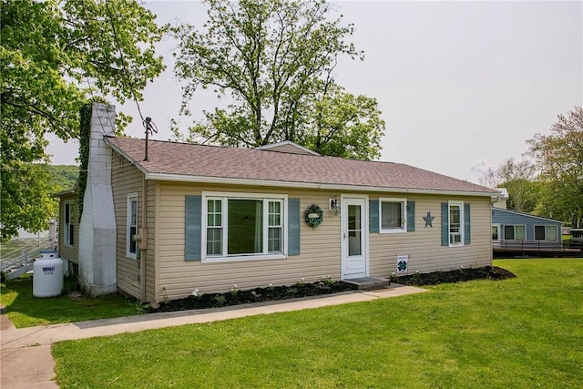 ranch-style home with a front lawn