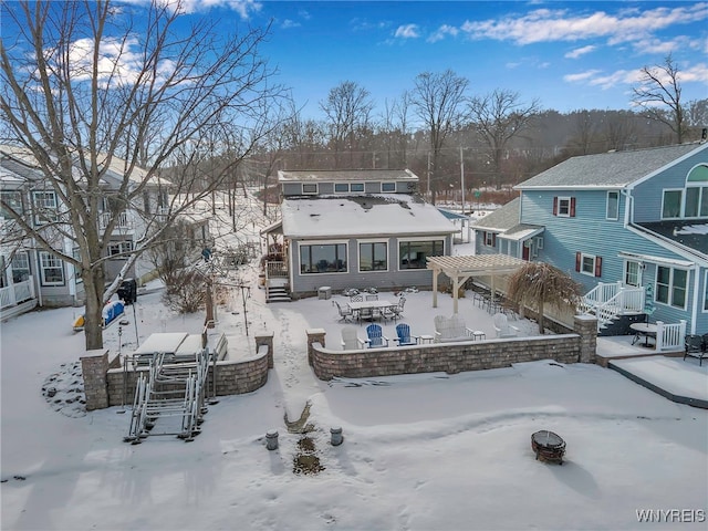 snow covered property featuring a pergola and a fire pit