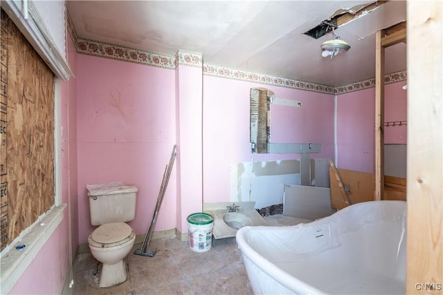 bathroom with toilet and a tub