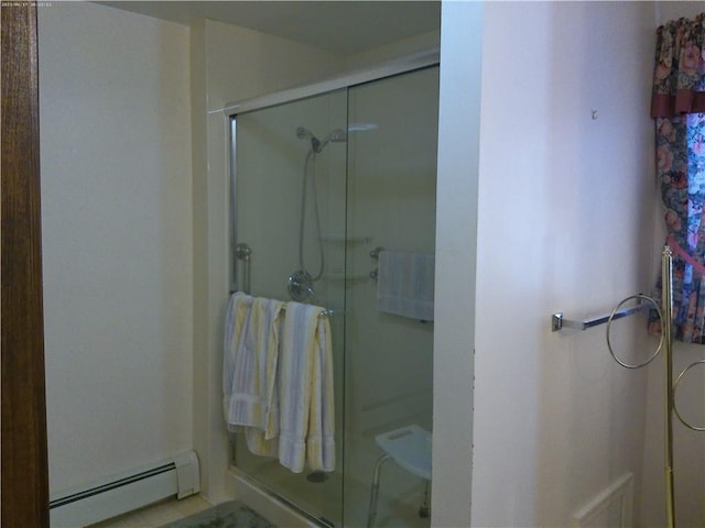 bathroom featuring an enclosed shower and baseboard heating