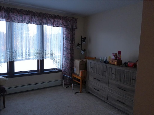 bedroom with baseboard heating, carpet floors, and multiple windows