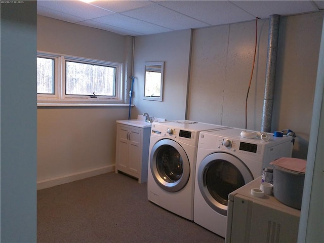 washroom with cabinets, sink, and washing machine and clothes dryer