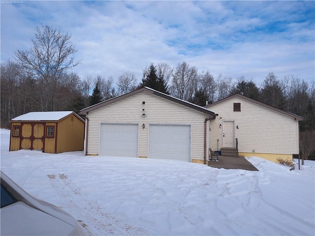 view of front facade with a garage and a storage unit