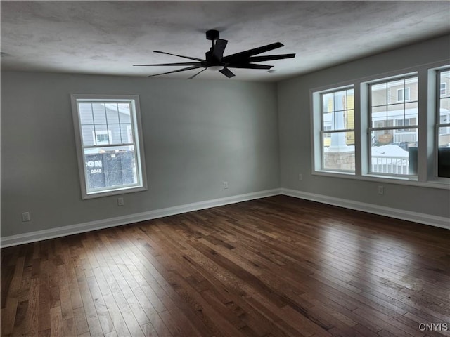 unfurnished room with ceiling fan and dark hardwood / wood-style flooring