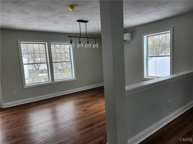 unfurnished dining area featuring a wall unit AC and dark hardwood / wood-style flooring