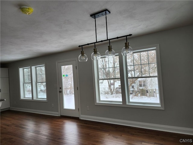 unfurnished dining area featuring dark hardwood / wood-style floors