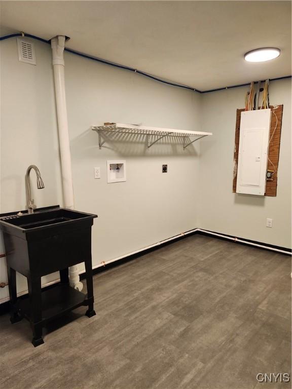 washroom featuring sink, dark hardwood / wood-style floors, washer hookup, and electric panel