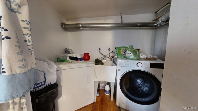 clothes washing area featuring separate washer and dryer and dark hardwood / wood-style floors