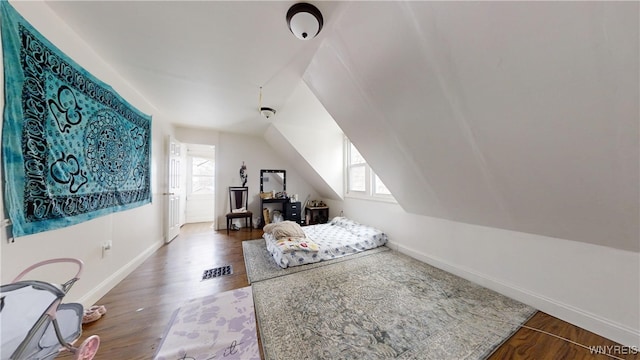 bedroom with vaulted ceiling and wood-type flooring