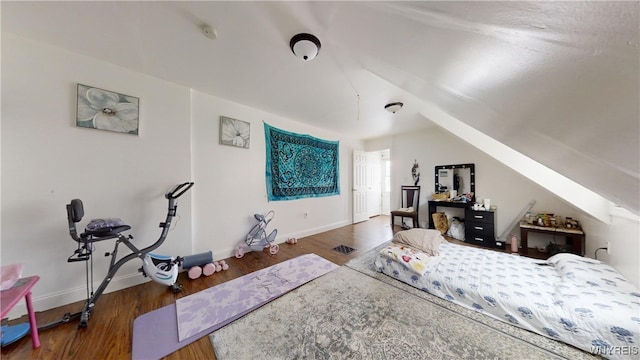 bedroom with lofted ceiling and dark wood-type flooring