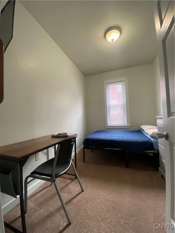 bedroom with light carpet and vaulted ceiling