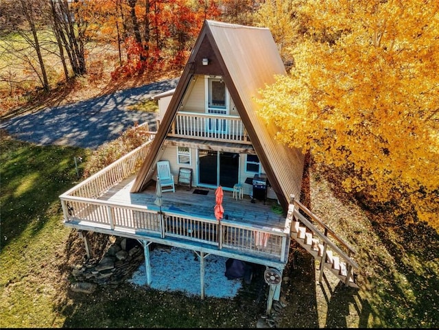 rear view of property with a wooden deck