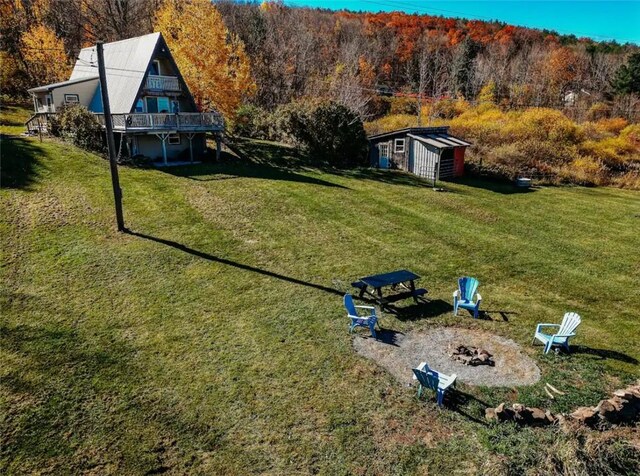 view of yard featuring an outbuilding and a fire pit