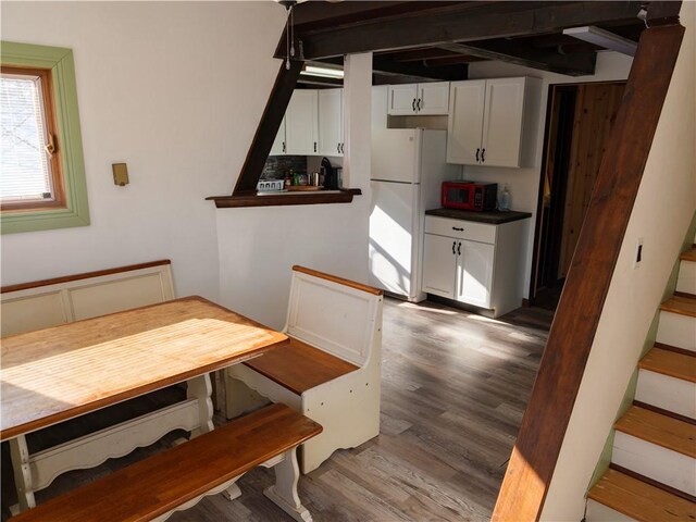 dining area with dark hardwood / wood-style floors