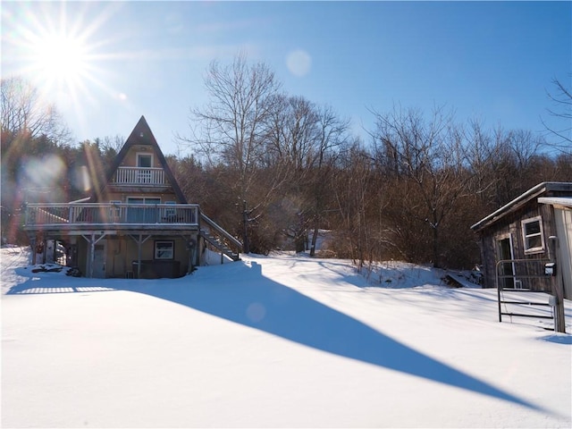 snowy yard with a wooden deck