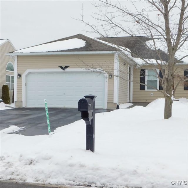 snow covered property featuring a garage