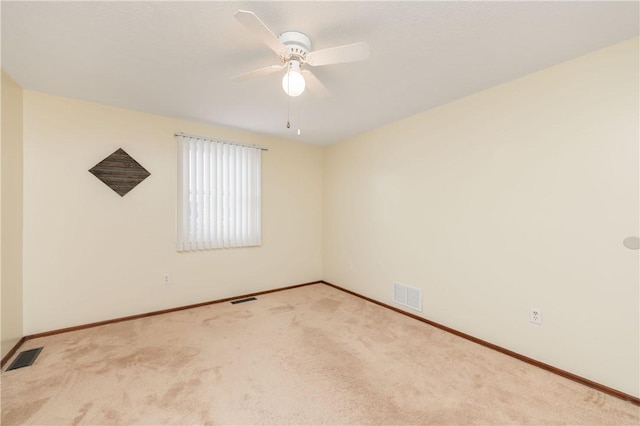 carpeted spare room with ceiling fan