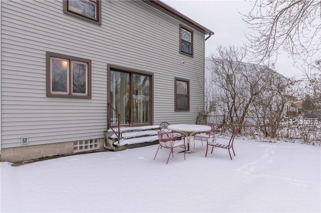 view of snow covered rear of property