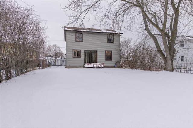 view of snow covered rear of property