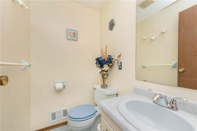 bathroom with toilet and vanity