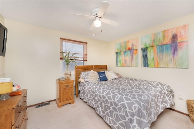 bedroom with ceiling fan and light carpet