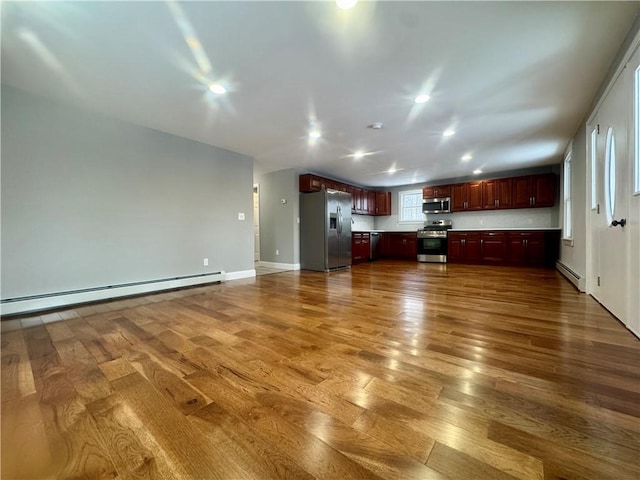 interior space with hardwood / wood-style flooring and a baseboard radiator