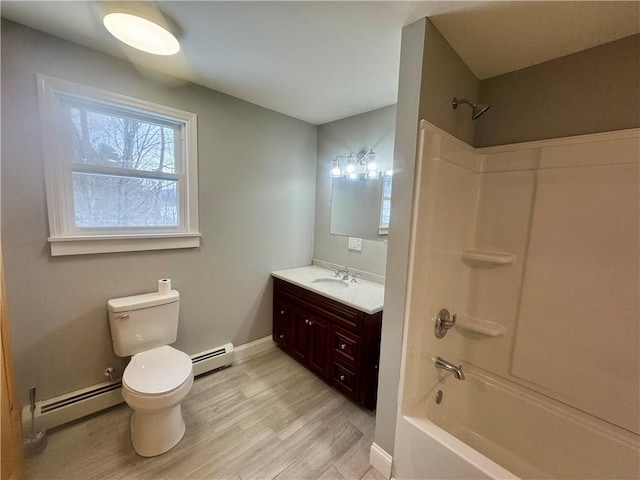 full bathroom featuring hardwood / wood-style flooring, baseboard heating, vanity, and  shower combination