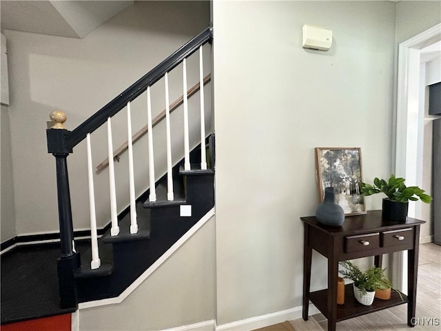 staircase featuring hardwood / wood-style flooring