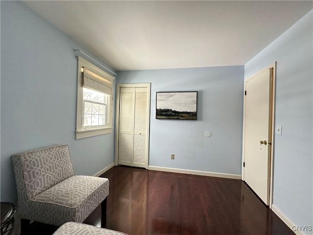 sitting room with dark hardwood / wood-style flooring