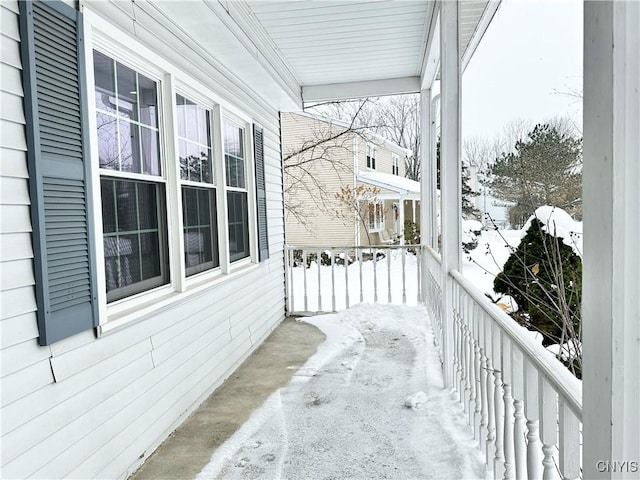 view of snow covered back of property